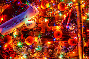 Christmas cap, garland, Christmas decorations on a wooden background.