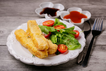 Fish sticks  and salad on a plate