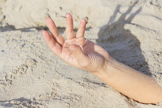 Hand Closeup. Hands Buried In Sand On A Beach.