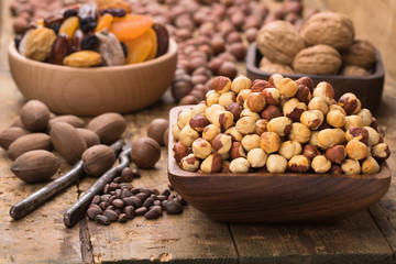 hazelnut peeled roasted in wooden bowl on table, grunge style.