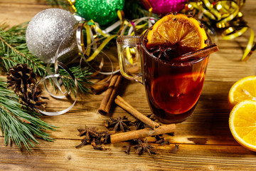 Christmas mulled wine with spices and Christmas decoration on wooden table