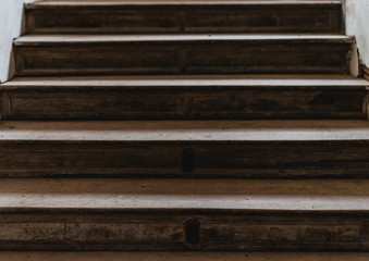 Old large wooden stairs in a bright white hallway of a castle on an Autumns day
