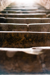 Large cold stone stairs leading up to the sun in a bright environment