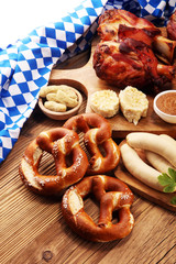 Traditional German cuisine, Schweinshaxe roasted ham hock. Beer, pretzels and various Bavarian specialties. Oktoberfest background