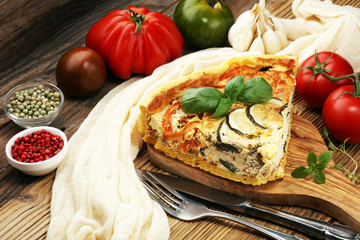 Homemade Cheesy Egg Quiche for Brunch with Spinach and Tomato, onions and zucchini.
