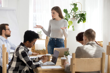 Five businesspeople at seminar sitting in office boardroom Young serious confident boss coach...