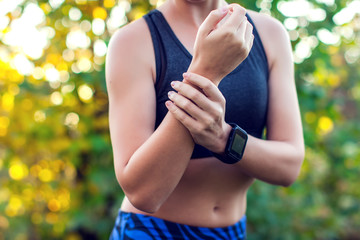 Woman have a wrist pain outdoor. Healthcare, medicine and people concept