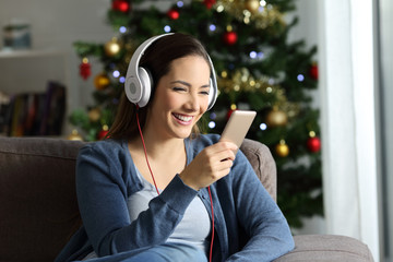 Girl listening to music in christmas at home