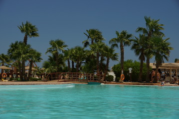 Fototapeta premium all inclusive hotel with blue swimmingpool and bar into the pool great cocktails