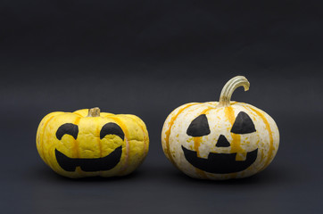 Cute Halloween pumpkins with happy expression against black background. Halloween pumpkin heads with smiles on black background