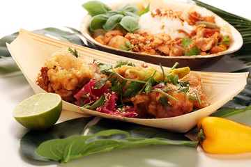 various street food with chicken wings on rustic background. balinese nasi campur and indian and brasilian street food.