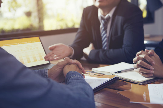 Businessmen And Their Customer Are Negotiating A Trade Agreement Or Business Plan.