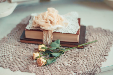 Delicate composition with old books decorated in rustic style