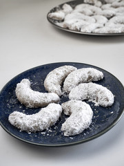 Crescent Cookies on Blue Plate in Front of Platter