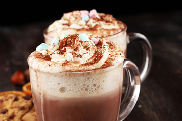 Hot chocolate cocoa with whipped cream on table.