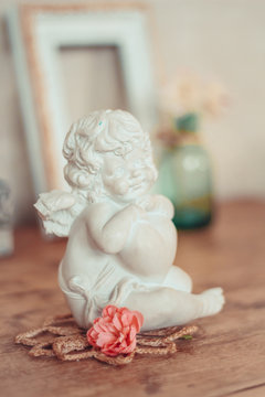 Delicate composition with a figure of an angel decorated in rust