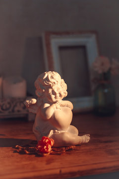 Delicate composition with a figure of an angel decorated in rust