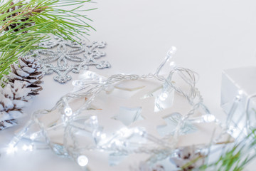 Holiday composition with pine branches and a garland