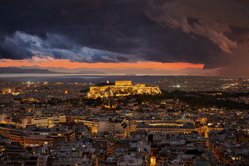 Illuminated Acropolis of Athens Greece at cloudy sky