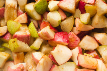 apple and pears pieces, sugar and syrup in pan, ready for boiling. Homemade red apple and pears jam, process of cooking