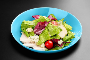 Salad cherry tomatoes leaves greens chicken breast basil Concept healthy meal black background menu restaurant