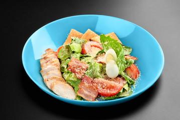 Fototapeta na wymiar Salad tomatoes leaves chicken breast bacon eggs basil Concept healthy meal black background menu restaurant