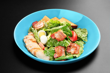 Salad tomatoes leaves chicken breast bacon eggs basil Concept healthy meal black background menu restaurant