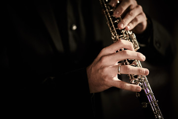 Oboe player on dark background musician