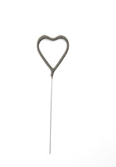 Unused single gray heart shaped sparkler isolated on white. Product concept.