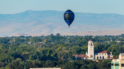 Single Hot Air Balloon floats of the train depot in Boise Idaho in the early morning