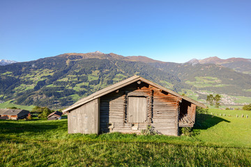 Alpine pasture hike to an old wooden barn with mountain meadow in the austrian alps, Zillertal Austria