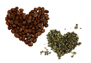 Heart consisting of coffee beans and a heart of dried green tea leaves isolated on white background. Love of tea and fragrant coffee