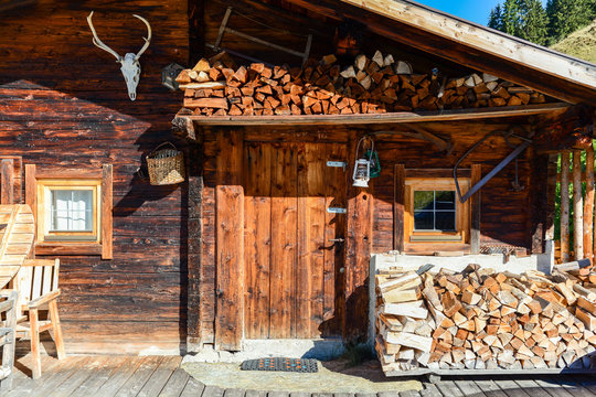 Fototapeta Entrance door to old wooden cabin at mountain meadow in the austrian alps, Zillertal Austria