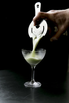 bartender pouring cocktail