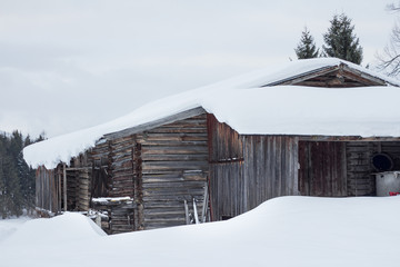 wooden hut covered in snow