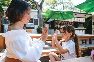Mother and daughter are sitting in a cafe