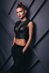 Fashion model with a red lips, model on a gray background