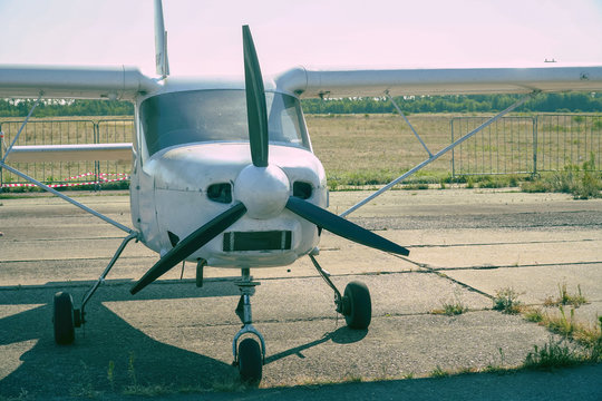 Light single-engine aircraft at the airport. Front view