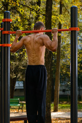 athlete muscular man on a sports field workout.