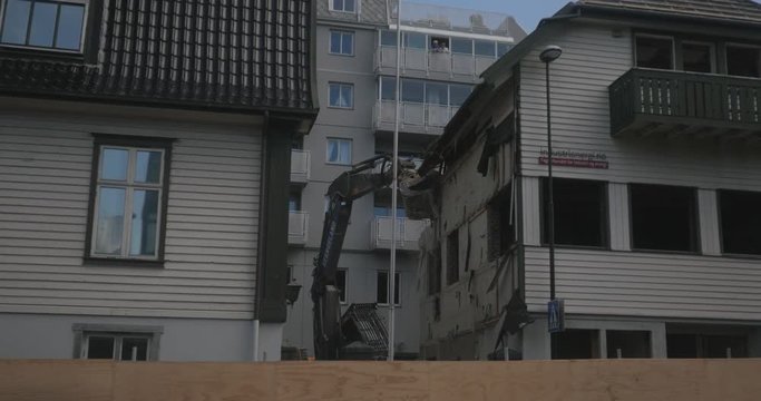 excavator demolishing building. Stavanger, Norway. 4K.