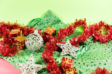 Christmas decoration with white balls and red gifts and green and red background
