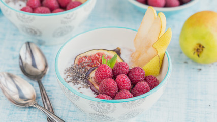 Smoothie bowl with fresh fruits, chia seeds, raspberry and fig