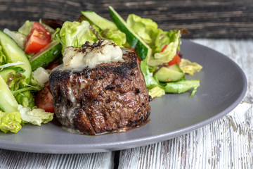 Grilled steak meat with potato gratin and vegetables