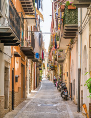 Fototapeta na wymiar A cozy street in Cefalù on a sunny summer day. Sicily, southern Italy.