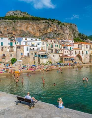 Fotobehang Cefalù waterfront with peole relaxing on a sunny summer day. Sicily, southern Italy. © e55evu