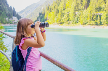 girl looking through binoculars