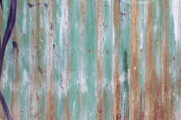 Green brown paint on wooden plank or fence.