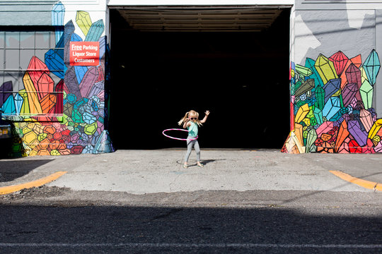 Little girl playing with hula hoop