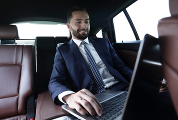 Confident businessman sitting in car