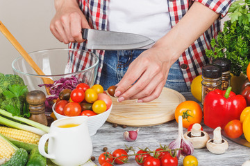 Woman cooks on the kitchen, soft focus background